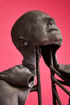 cast lead sculpture on pink background