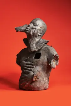 Cast lead and wax sculpture on red background