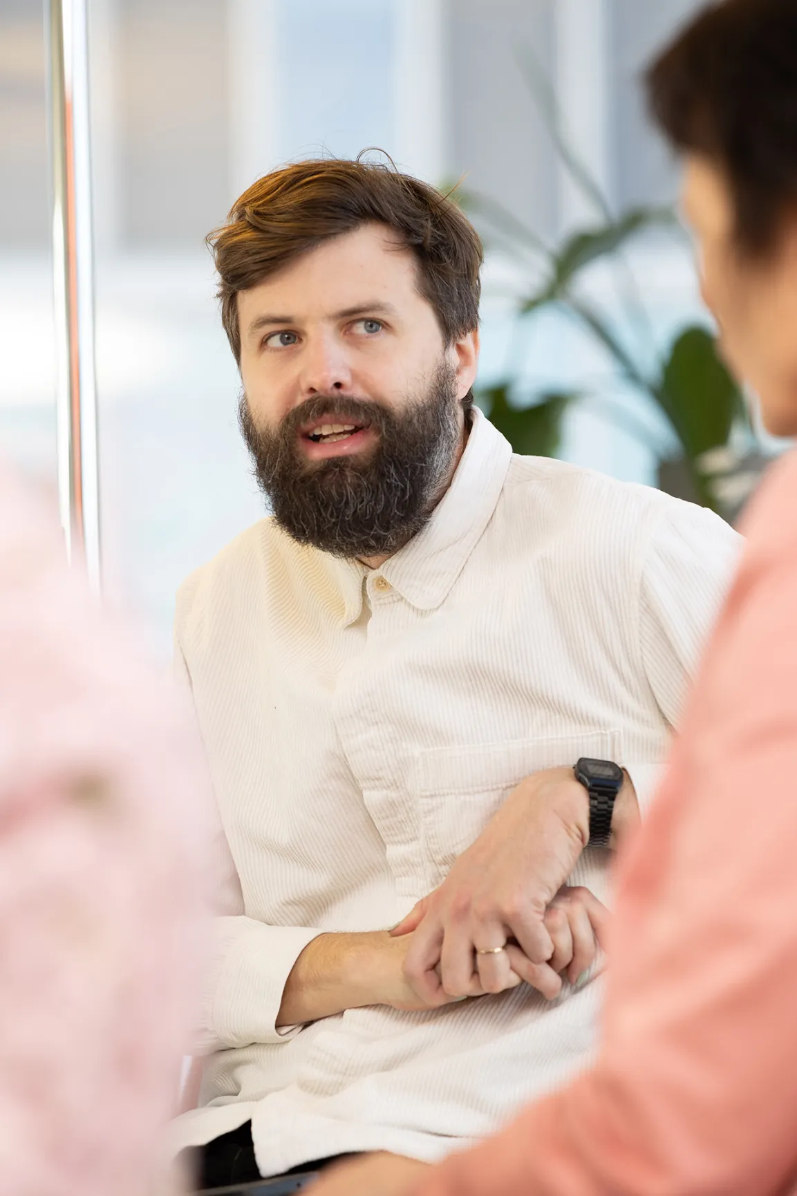 Personen sitzen an einem Bürotisch und diskutieren
