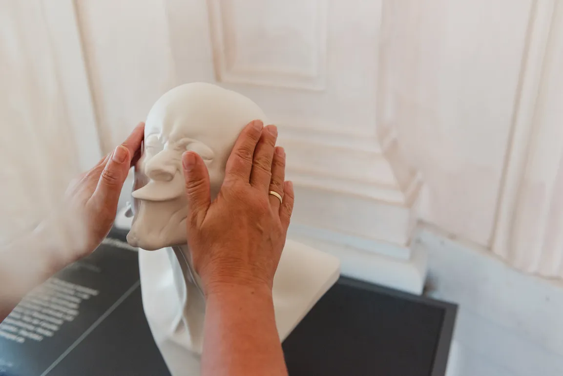 Hands touching a Messerschmidt head
