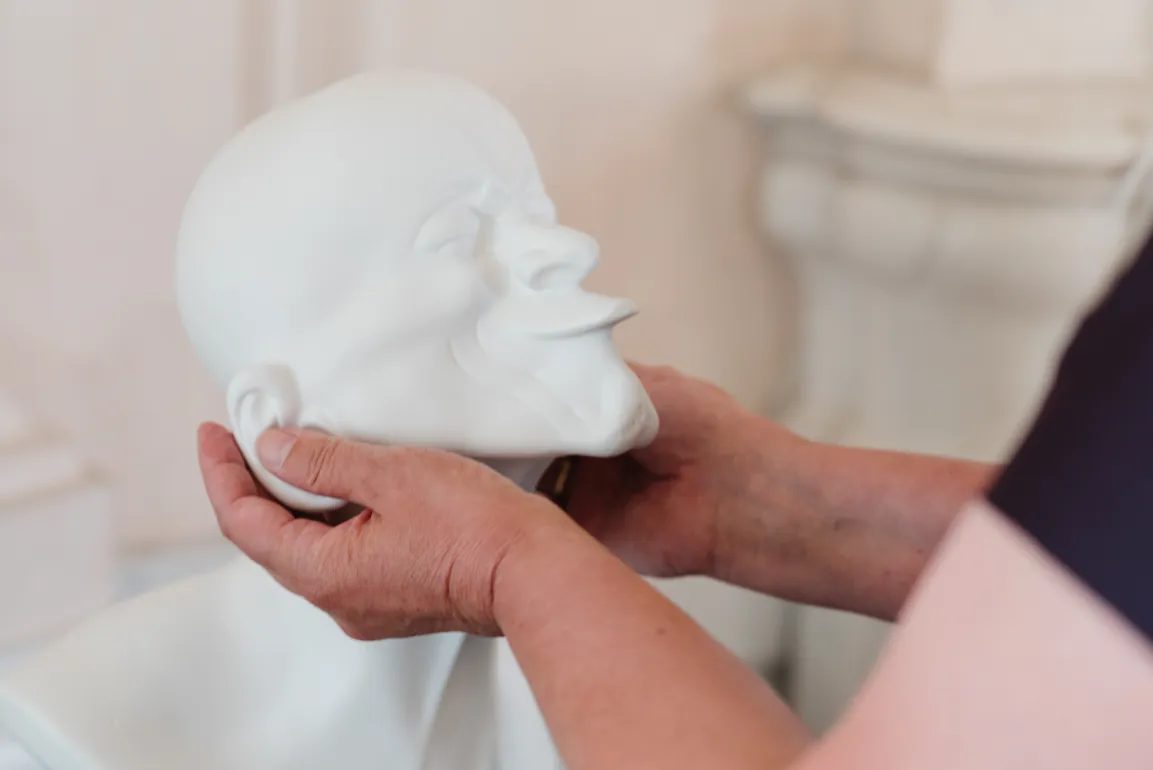 Hands touching a Messerschmidt head