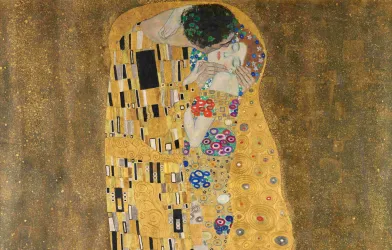 The image depicts a couple embracing. The figures are surrounded by a shiny golden background that is richly adorned. The one figure appears to be wrapped in a magnificent garment decorated with various patterns and floral motifs. Their faces are close together, and their eyes are closed, conveying an intimate and deep connection. The lower part of the image is filled with a lush vegetative depiction. [AI-generated with ChatGPT]