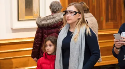 Young woman are looking at a picture in the museum.