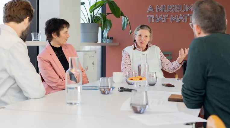 People sitting at an office desk and discussing